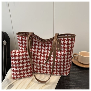 Detail of red houndstooth tote bag and zipper pouch set with brown leather trim