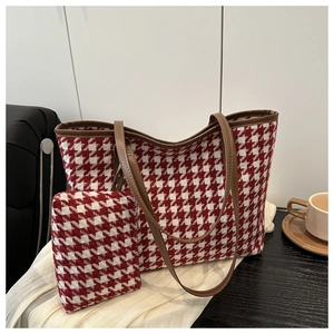 Detail of red houndstooth tote set with matching pouch on a dark wooden table
