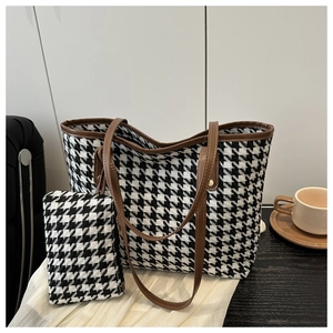 Detail view of houndstock pattern tote bag set with brown leather straps on silk background
