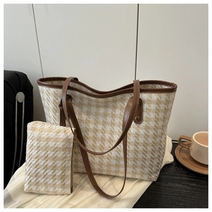 Detail of woven tote bag with matching zippered pouch and premium leather trim finish
