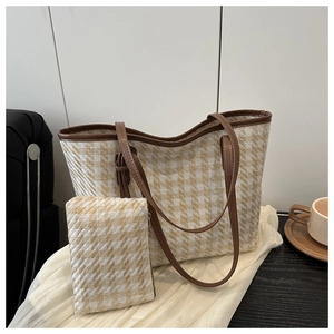 Close-up of woven tote bag with herringbone pattern and matching smaller pouch