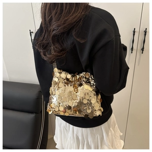 Detail of sequin chain crossbody bag showing large gold discs and metallic texture