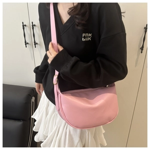 Detail of pink soft PU leather half-moon crossbody bag with adjustable strap and zipper