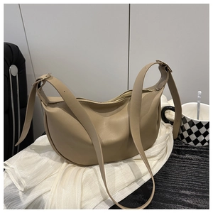 Detail of khaki crescent crossbody bag with smooth leather finish and adjustable strap