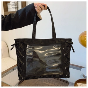 Detail of black ita bag with transparent window and ribbon lace-up decoration