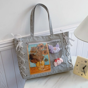 Large gray tote bag with transparent window and ribbon details for spring 2025 fashion