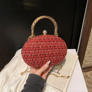 Elegant red tweed evening bag with gold handle and sparkling rhinestone ball clasp