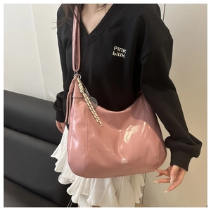 Pink glossy hobo bag detail with tennis racket charm and COIH 12DN logo print