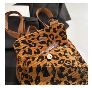 Detail of leopard print corduroy bag with silver magnetic snap button closure