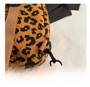 Detail shot of the detachable matte hook and leopard print corduroy strap
