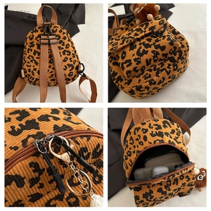 Detail showing leopard print corduroy mini backpack with zipper and magnetic pocket