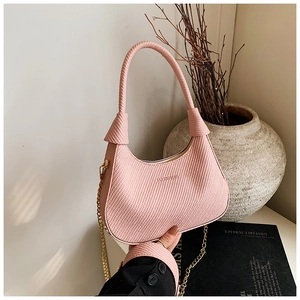 Detail of pink woven hobo bag with gold chain strap and elegant brand logo engraving
