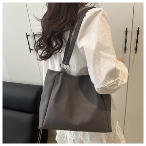 Detail of canvas tote bag with metal ring hardware and thick fabric texture
