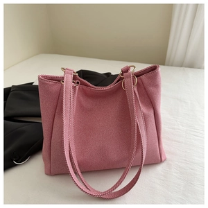 Detail of pink canvas tote bag with metal ring connectors on white and black background