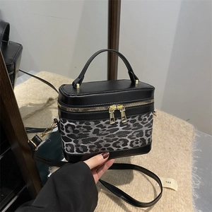 Chic leopard print bucket bag with black leather trim and detachable shoulder strap