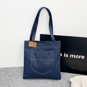 Large capacity navy blue denim tote bag with brown leather patch and outer pocket
