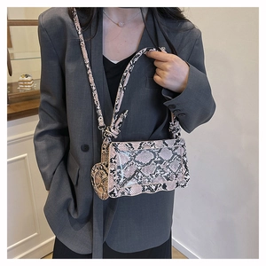 Detail of pink and black snake print texture on a rectangular fashion crossbody bag