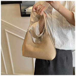 Detail of beige hobo bag with woven texture and metal zipper for stylish daily commute