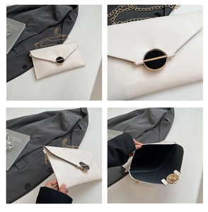 Détails d'un sac enveloppe blanc avec chaîne dorée et fermeture magnétique