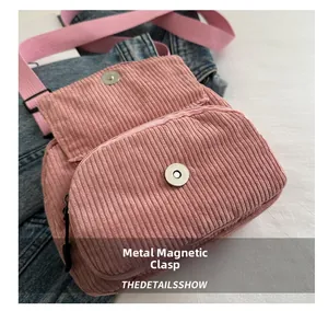 Close-up of pink corduroy crossbody bag featuring a durable magnetic snap button