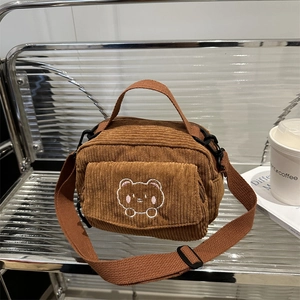 Brown corduroy crossbody bag with cartoon bear embroidery and adjustable shoulder strap