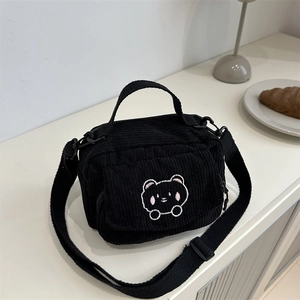 Black corduroy crossbody bag featuring a cute bear embroidery and adjustable strap