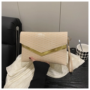Detailed macro view of beige envelope clutch with gold V-trim and textured ripples