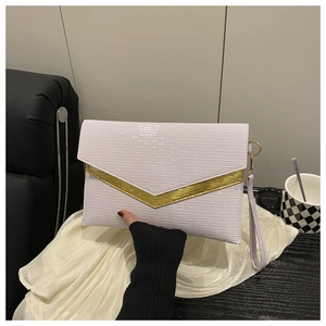 Detail of envelope clutch bag featuring gold V-trim, wavy embossing and wrist strap