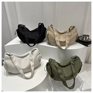 Detailed view of large nylon crescent bags in black, khaki, beige and olive green