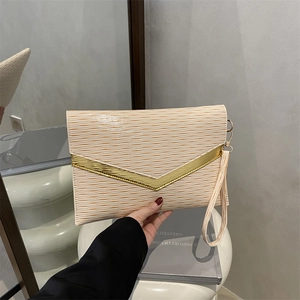 Elegant cream envelope clutch bag with wavy texture and gold V-shaped metal hardware