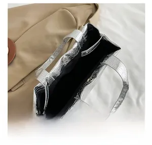 Top view of silver crocodile embossed tote bag with magnetic snaps and spacious interior
