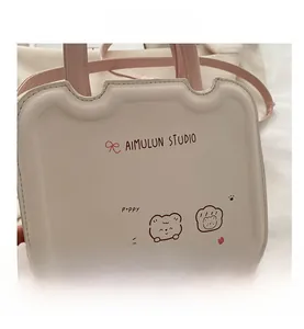 Detail of cream PU leather handbag featuring cute bear prints and wavy top design