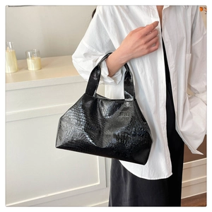 Close-up of black crocodile pattern faux leather texture on minimalist tote bag