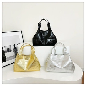 Three trapezoidal tote bags in shiny black, metallic gold and silver with croc texture