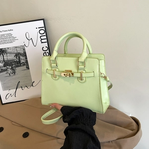 Chic mint green structured handbag for women featuring gold hardware and a crossbody strap