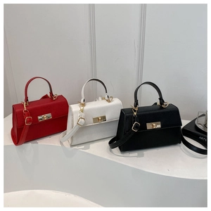 Close-up of pebble leather texture and gold metal lock on stylish crossbody flap bags