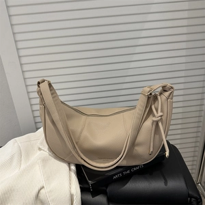Minimalist beige pebbled leather hobo bag with adjustable strap and zipper closure