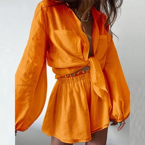 Women's bright orange two-piece cotton linen set with tie-up shirt and ruffled shorts