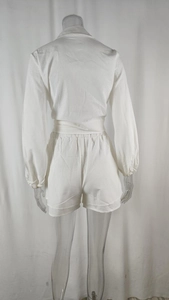 Rear view of white casual two-piece set featuring waist-tie shirt and shorts on mannequin