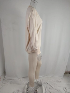 Detail view of beige ribbed long-sleeve sweatshirt and matching fitted jogger set