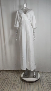 Detail shot of V-neckline and elastic waist pleats on this white wide-leg jumpsuit