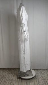 Close-up of white high-waist v-neck jumpsuit with short sleeves and wide-leg cut
