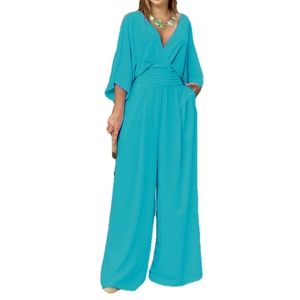 Elegant bright blue V-neck jumpsuit with batwing sleeves and high waist wide leg cut