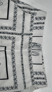 Detail of the high-quality boho print fabric with sun motifs and clean stitching on trousers