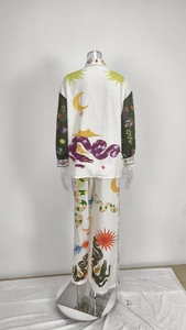 Rear view of fantasy print satin pajama set with green contrast sleeves on mannequin