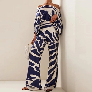 Elegant two-piece set with off-shoulder printed top and high-waist wide-leg pants