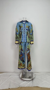 Detailed view of women floral shirt with lantern sleeves and matching wide-leg trousers