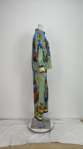 Detailed side view of silky floral print shirt and wide leg pants set with lantern sleeves