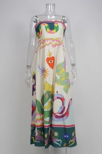 Detail of elegant white maxi dress featuring surreal art prints and abstract portraits