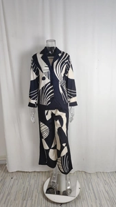 Close-up of geometric print fabric and lapel shirt detail on a two-piece pant set
